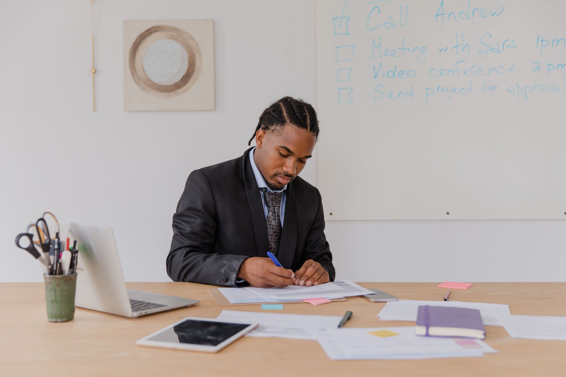Un indépendant vérifie avec attention une fiche d'établissement sur son bureau, entouré de documents.